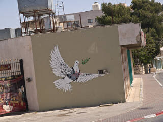 Banksy_-_Peace_Dove_-_2008_-_distant_view.jpeg